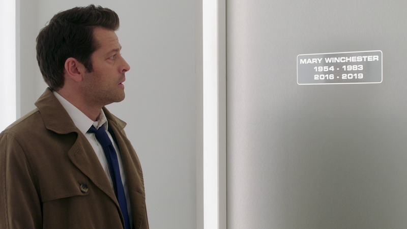 The angel Castiel (Misha Collins) looks at a door in heaven that is labeled "Mary Winchester, 1954-1983, 2016-2019"