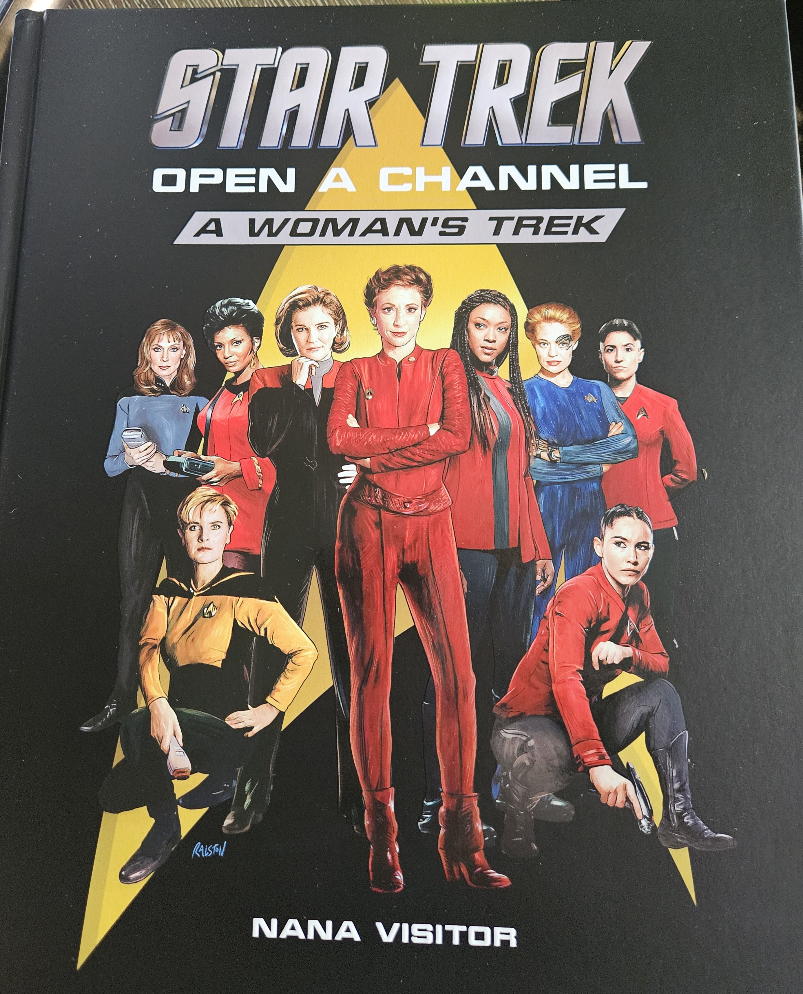 Picture of the book cover. From left to right: Dr. Crusher, Uhura, Captain Janeway, Kira Nerys, Michael Burnham, Seven of Nine, Erica Ortegas, and front row Tasha Yar and La'an Noonien Singh