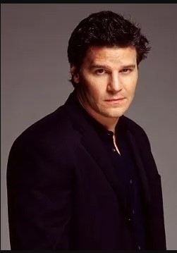 Angel (David Boreanaz), a brunet with spiked hair, dressed in black