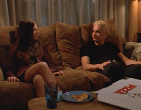 Dawn (Michelle Trachtenberg) and Spike (James Marsters) sitting on a couch with pizza on the coffee table in front of them