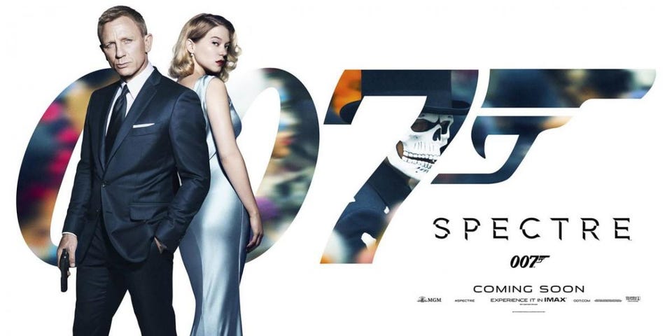 Daniel Craig and Lea Seydoux pose back-to-back in front of the 007 logo, with Spectre Coming Soon written in the lower right corner