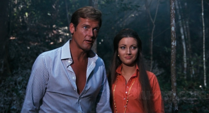 Roger Moore and Jane Seymour walk through a forest (Live and Let Die)