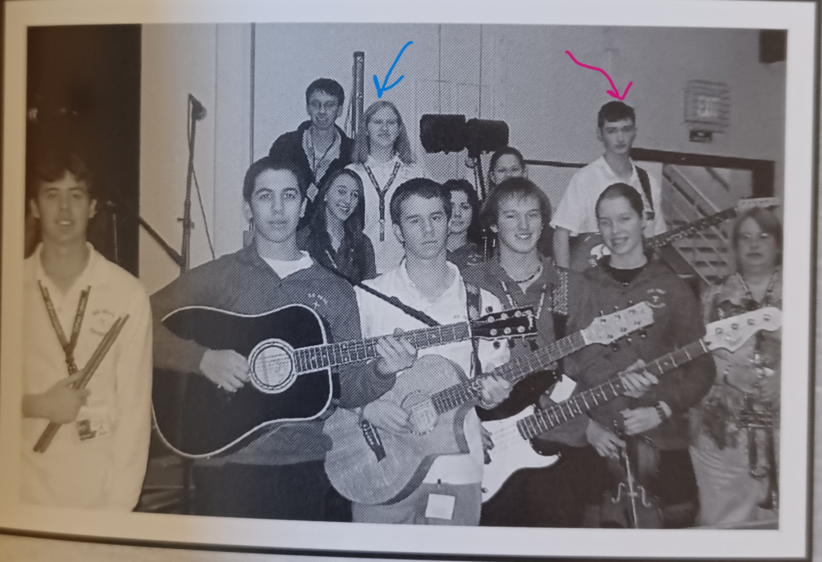 Image description: low-res black-and-white photo of a group of teenagers in school uniforms. In the back row, I'm standing with singers, while Bryan is holding his guitar.